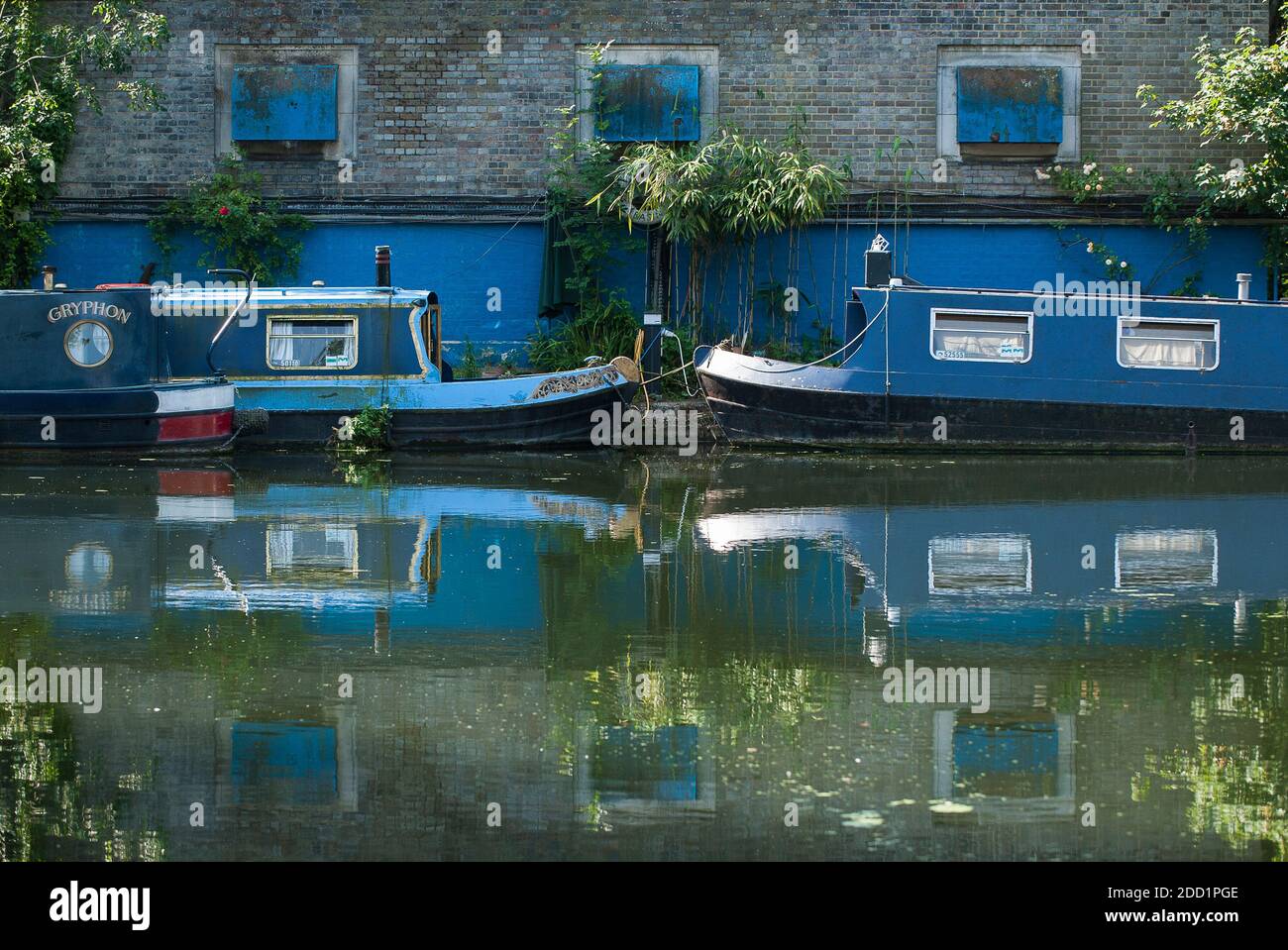 Blue canal boats along Regents Canal in London, UK. Stock Photo