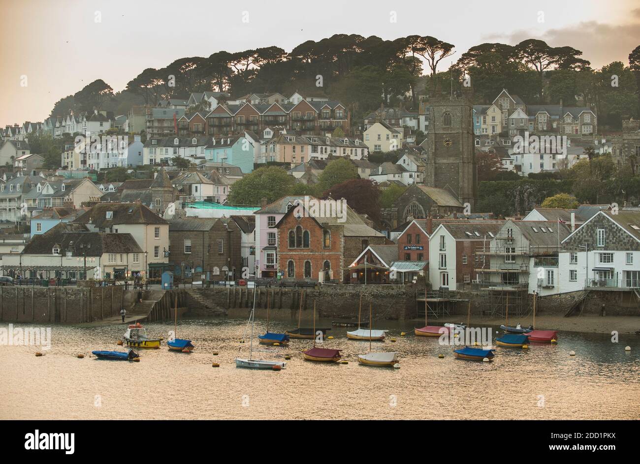 Small boats are anchored in front of the small coastal town of Fowey, Cornwall, England. Stock Photo