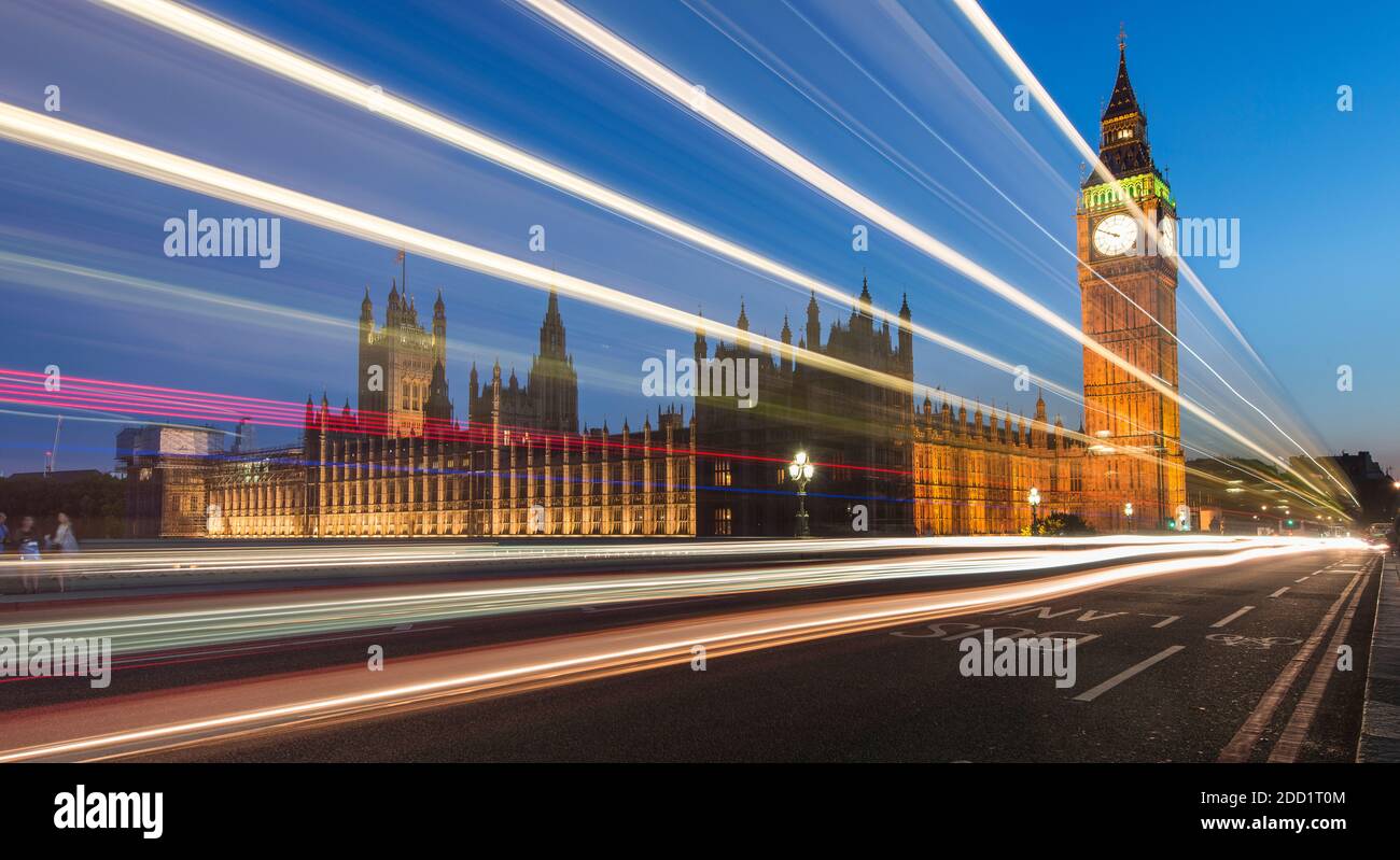 Cars drive past at twilight along the Westminster Bridge, Big Ben and the Houses of Parliament in London, England. Stock Photo
