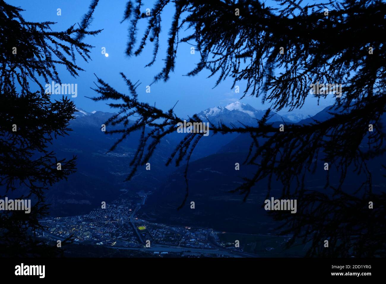 Contrasting view of Visp and the Dürrenhorn mountain at dusk. Stock Photo