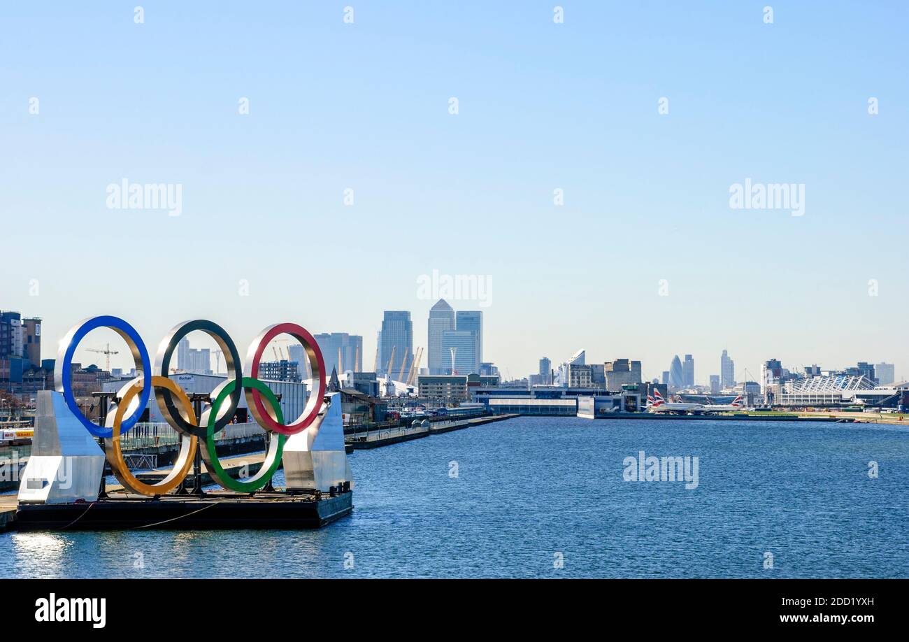 UK, London. Olympic Logo, King George V Dock. High rise Canary Wharf, Millenium Stadium (O2 Centre), London City Airport & Excel Centre (right). 2012. Stock Photo