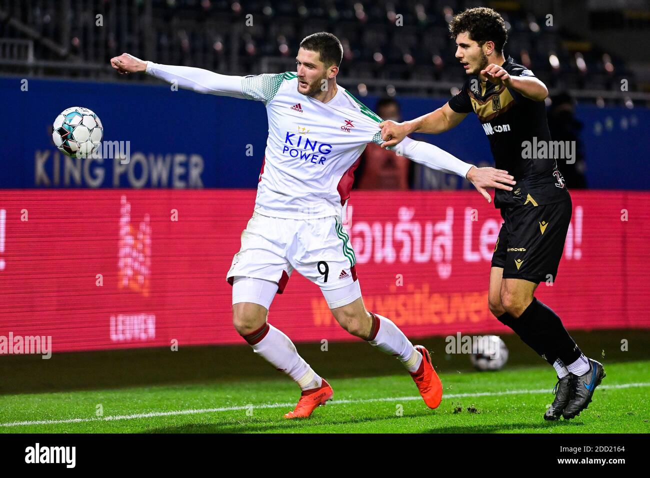 OHL's Thomas Henry and STVV's Liberato Cacace fight for the ball during