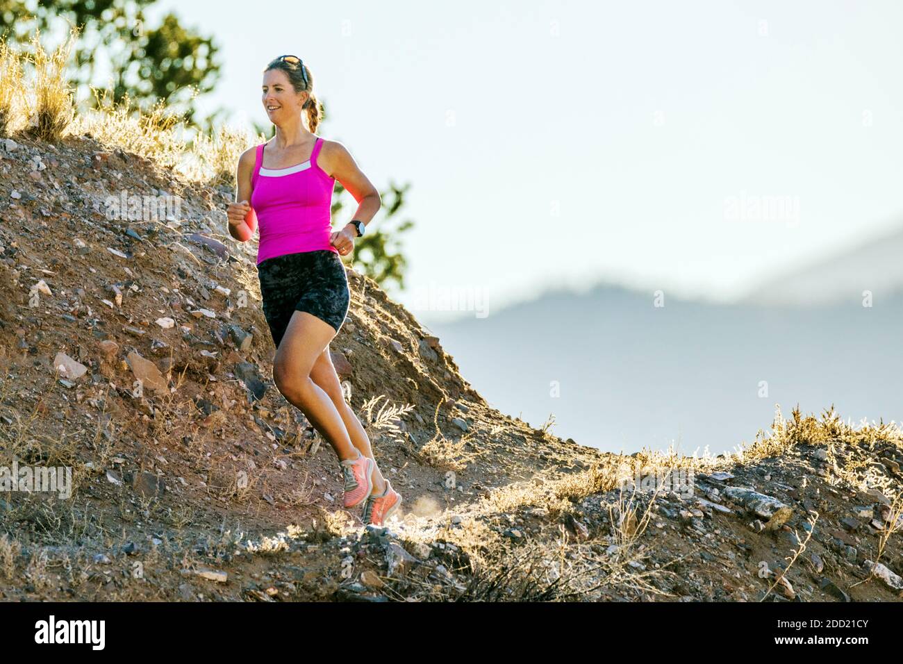 Attractive fit middle-aged woman running on mountain trails; Salida; Colorado; USA Stock Photo