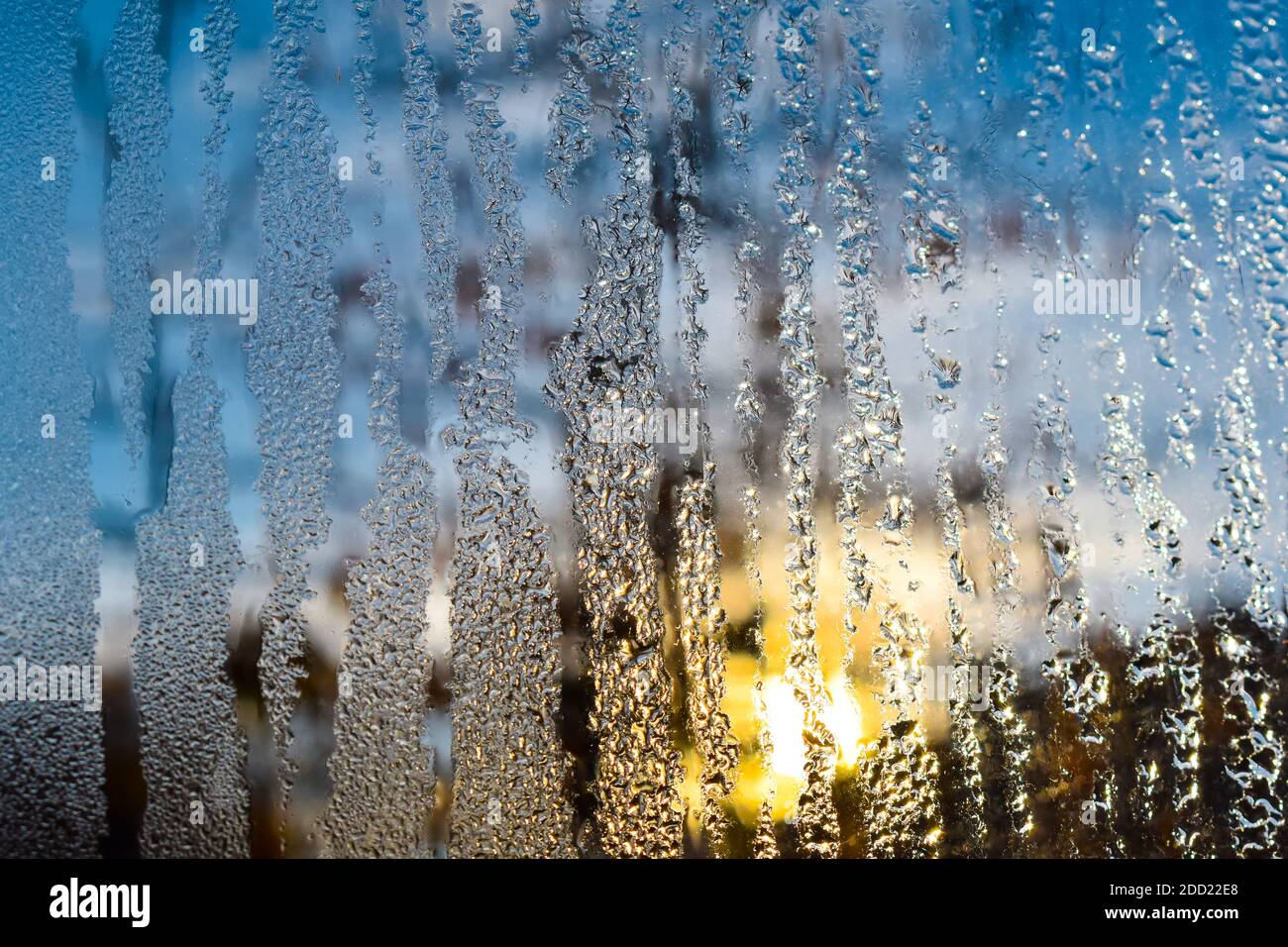 Frozen water drops on the window glass on a winter morning. Stock Photo