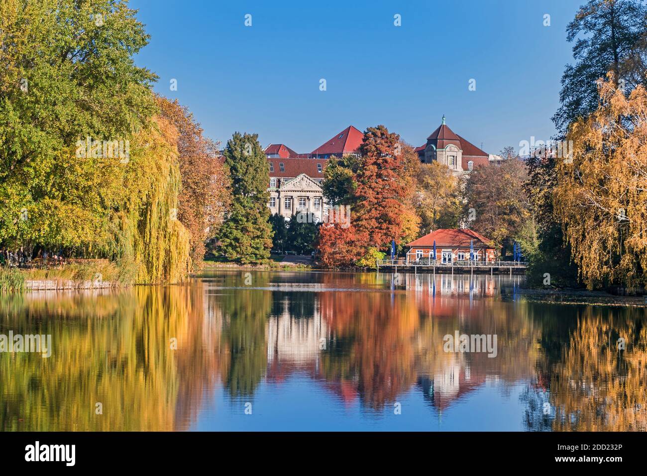 Berlin, Germany - November 7, 2020: Park and a listed garden Lietzensee with autumn coloured trees and buildings on the shore of Lake Lietzen with its Stock Photo