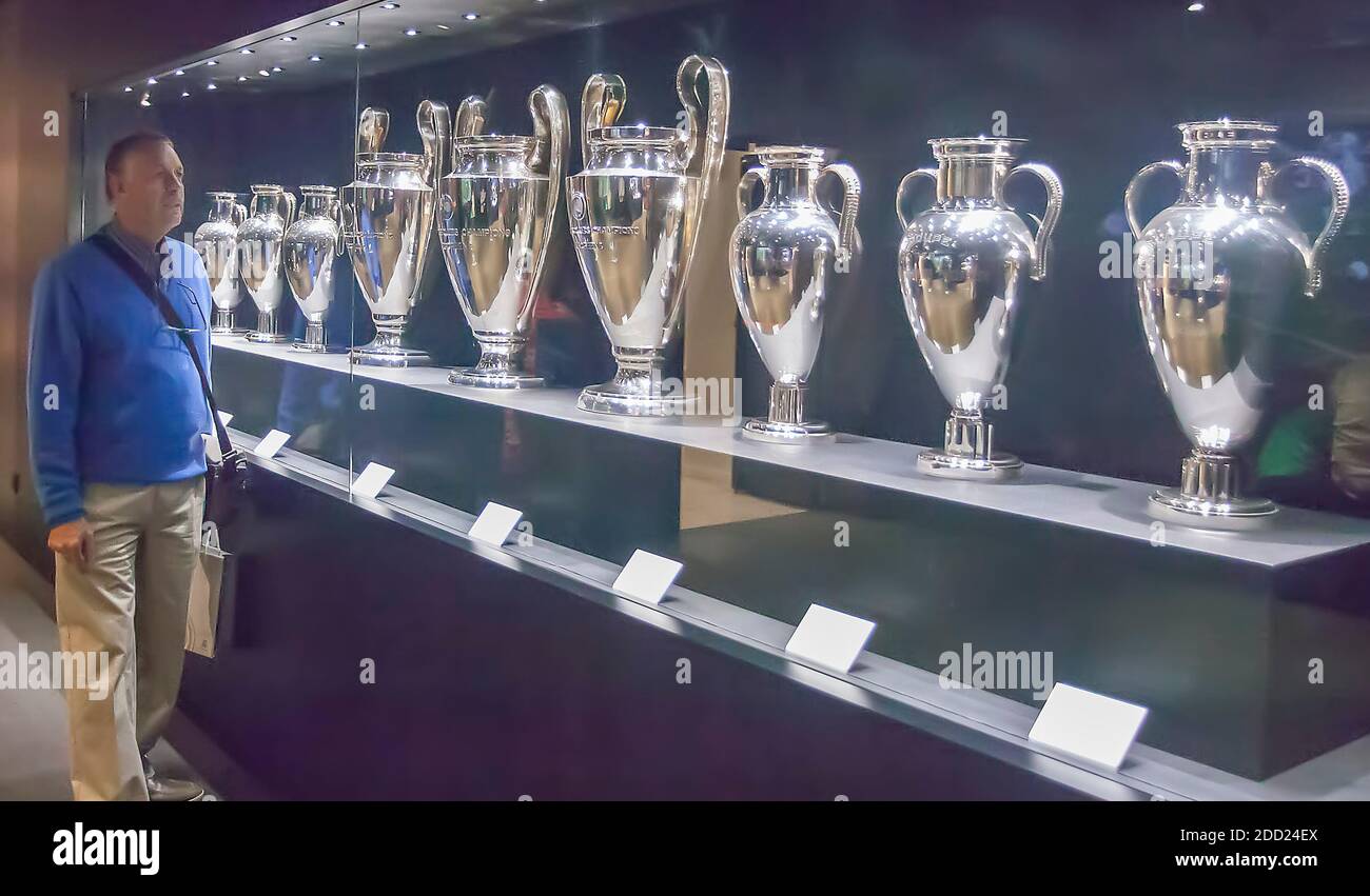 A man looks at silverware on display at Real Madrid Football Club, Madrid, Spain Stock Photo