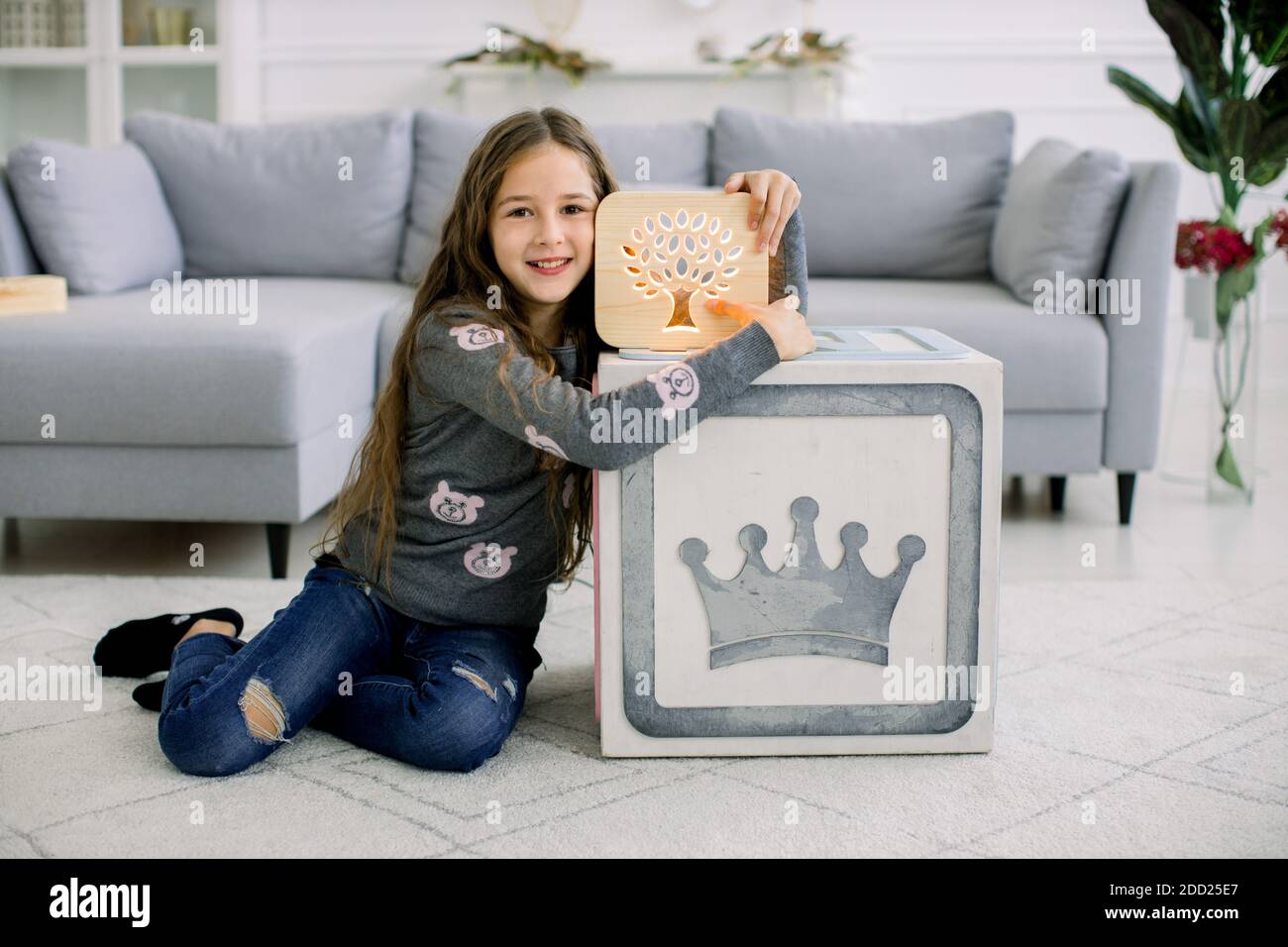 Little Girl With Wooden Night Lamp Sitting In Modern Cozy Light Living Room At Home Cute 10 Years Old Girl Posing To Camera With Night Lamp Indoors Stock Photo Alamy