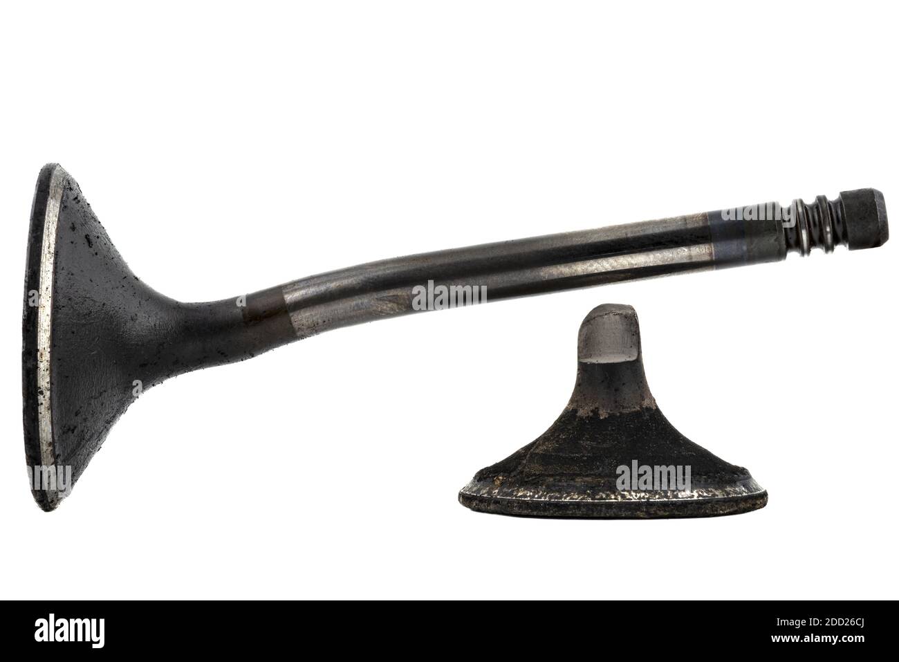 Warped and cracked engine valve spindle made of heat-resistant steel, covered with soot, isolated on a white background. Stock Photo