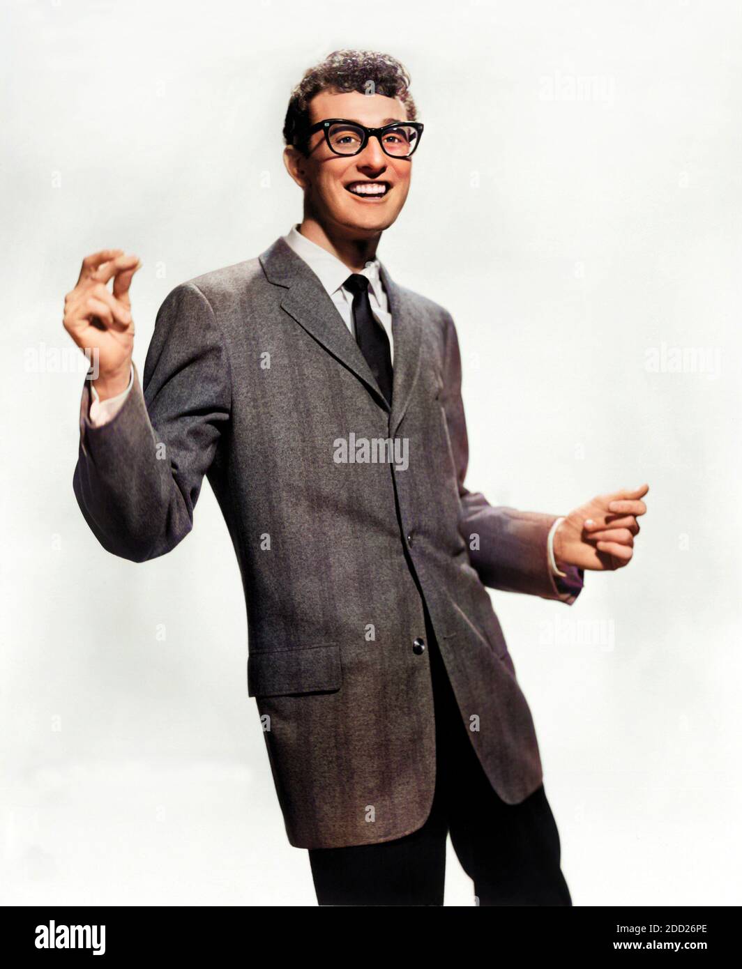 1958 ca. , USA : The celebrated  Rock'n Roll  star , guitarist , singer and songwriter BUDDY HOLLY ( 1936 - 1959 ). Buddy Holly dead on the ill-fated flight tyhe day 3 february 1959 that crashed on Clear Lake and killed him and also J.P. The Big Bopper Richardson and Richie Valens . Unknown photographer for Brunswick Records . DIGITALLY COLORIZED .-  ROCKABILLY - POP MUSIC - ROCK AND ROLL - ROCK'N ROLL - MUSICA LEGGERA - portrait - ritratto  - musicista - musician - chitarrista - musicista - ROCK - portrait - ritratto - ANNI CINQUANTA - 50's - '50 - lens - smile - sorriso - disastro aereo - da Stock Photo