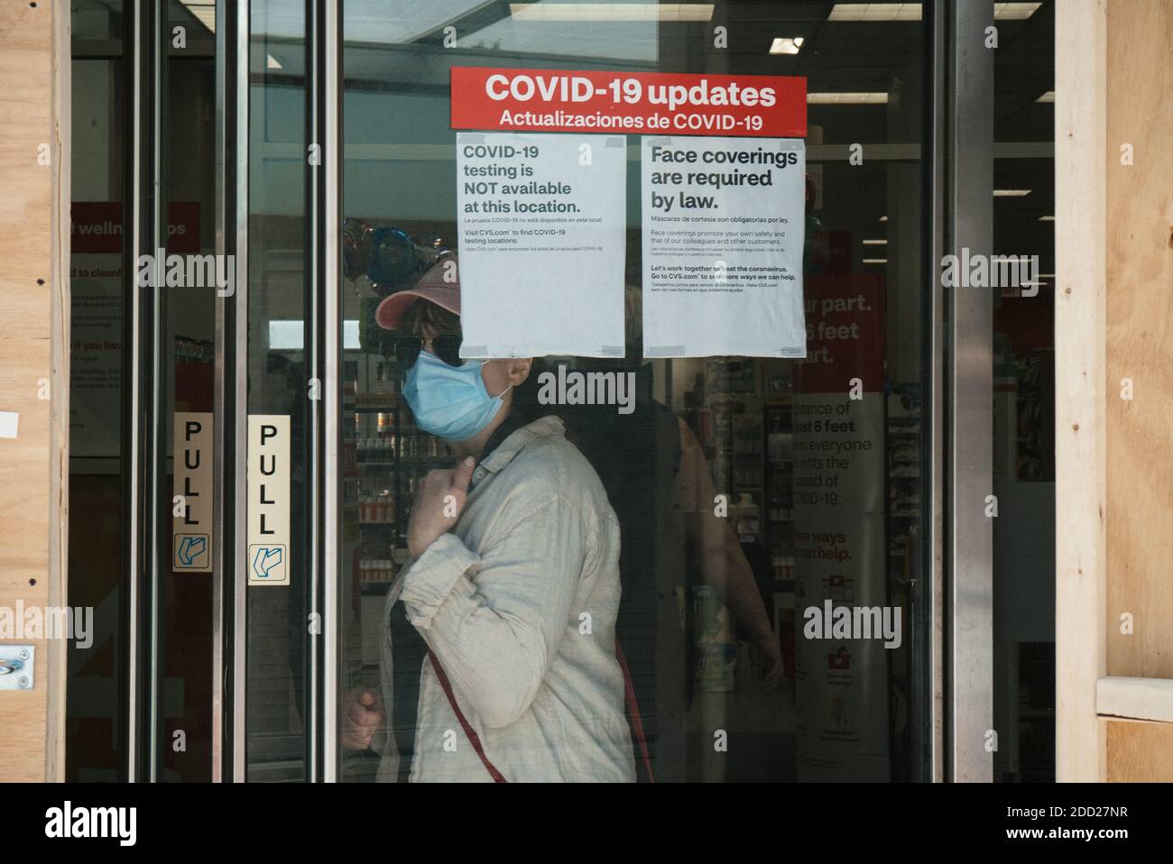 Manhattan, New York. June 09, 2020. A woman wearing a mask exits a CVS ...