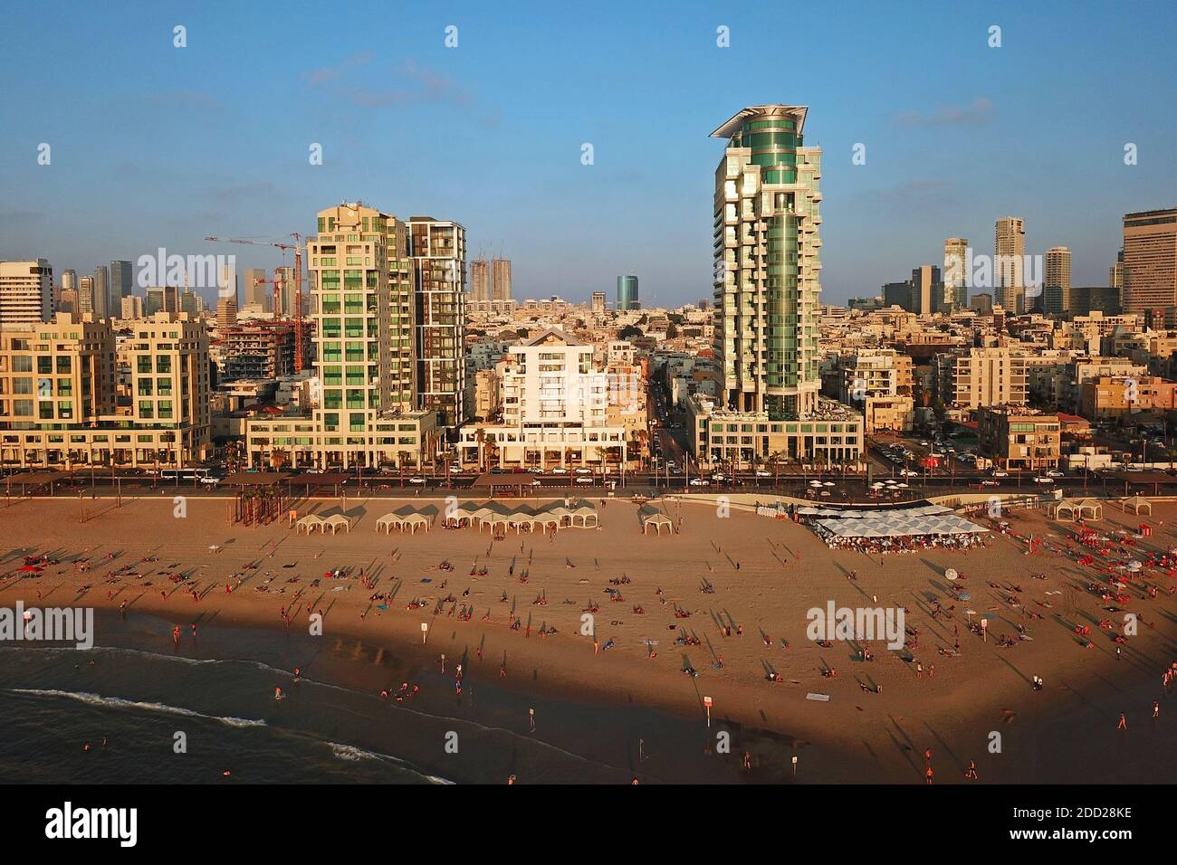 Aerial drone image of Tel Aviv, Israel waterfront at golden hour, featuring the Banana Beach and Royal Beach Hotel. Stock Photo