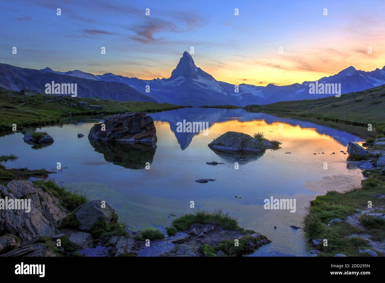 Sunset colors and Matterhorn silhouette reflecting in Lake Stellisee, above Zermatt in Switzerland Stock Photo