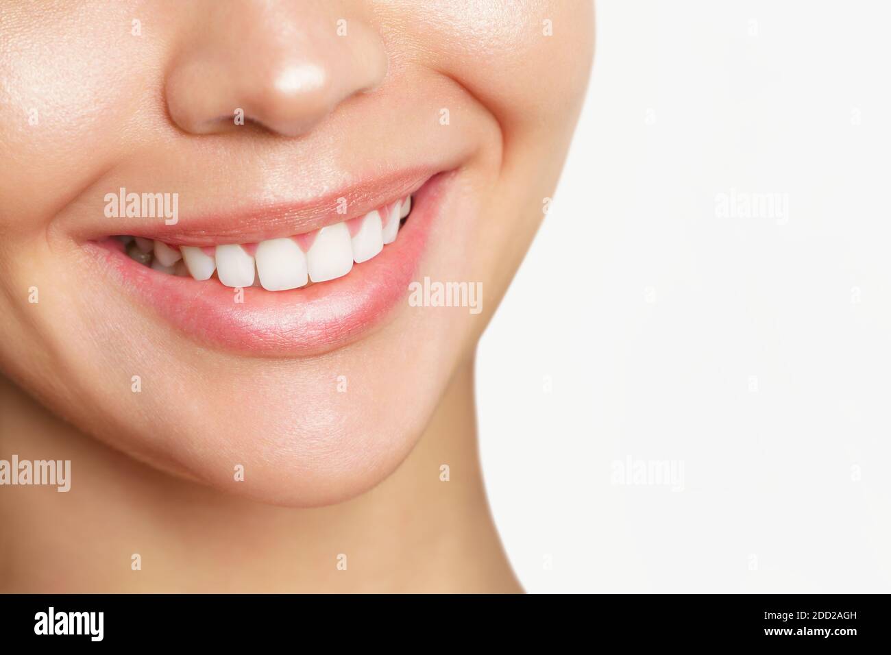 Beautiful young woman with healthy teeth on white background. Stock Photo