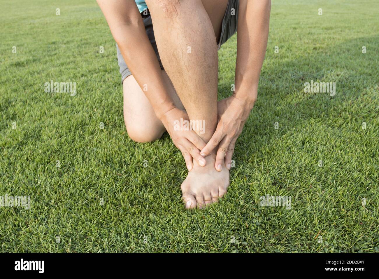 man ankle injury after running at Running field Stock Photo Alamy