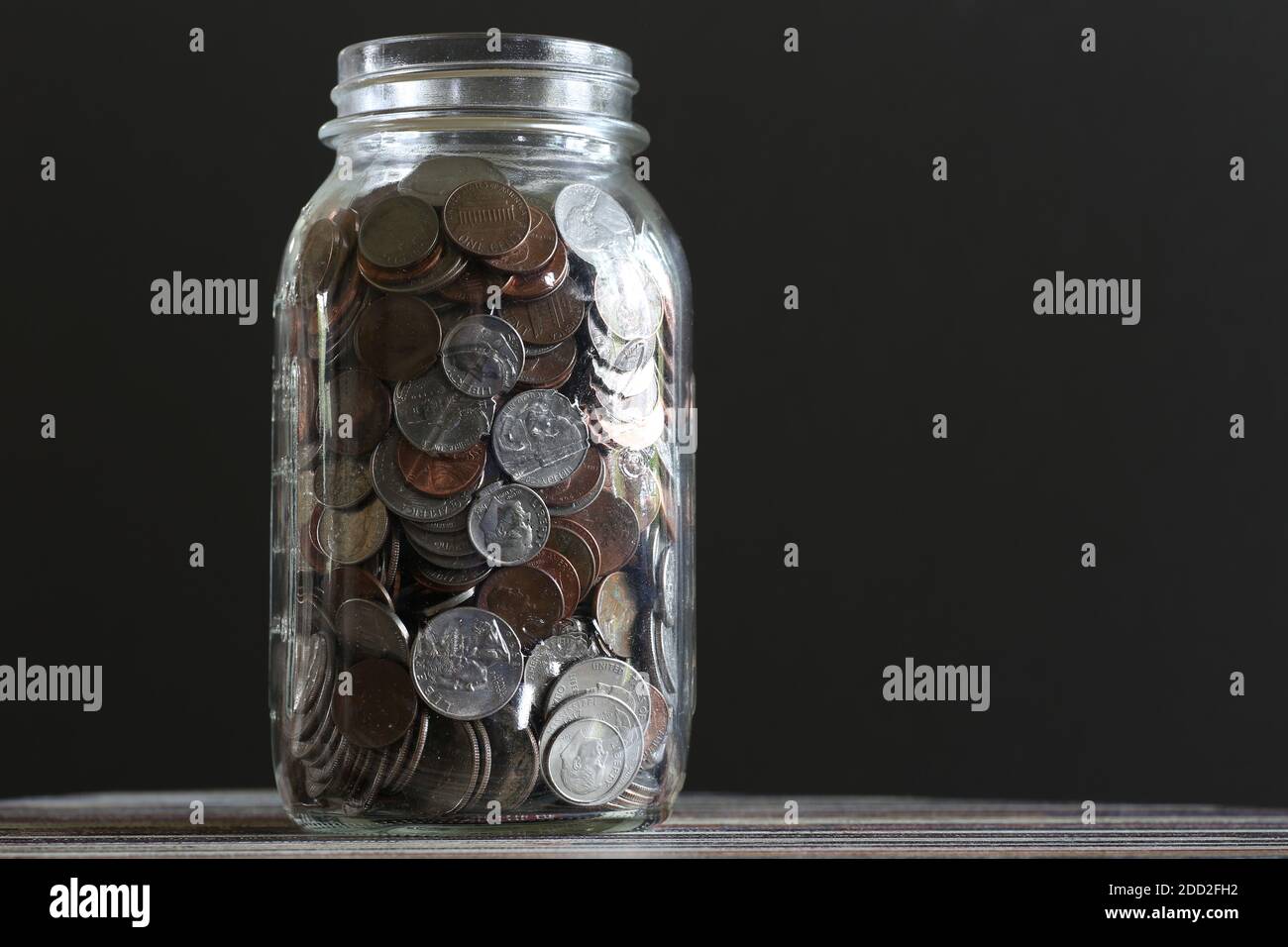 Coins in a jar Stock Photo Alamy