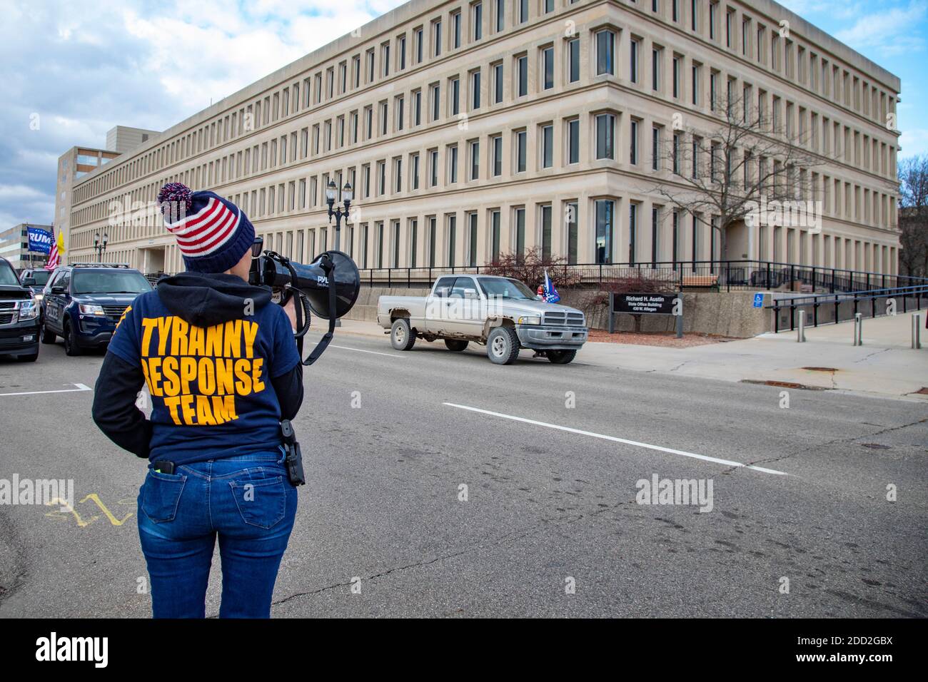 Lansing, Michigan, USA. 23rd Nov, 2020. An pistol-carrying supporter of President Trump wears a 'Tyranny Response Team' sweatshirt outside the Michigan Secretary of State office as the Michigan Board of State Canvassers meets to decide whether to certify the results of the 2020 presidential election. The board subsequently certified the results, which showed Joe Biden ahead of President Trump by about 150,000 votes. Credit: Jim West/Alamy Live News Stock Photo