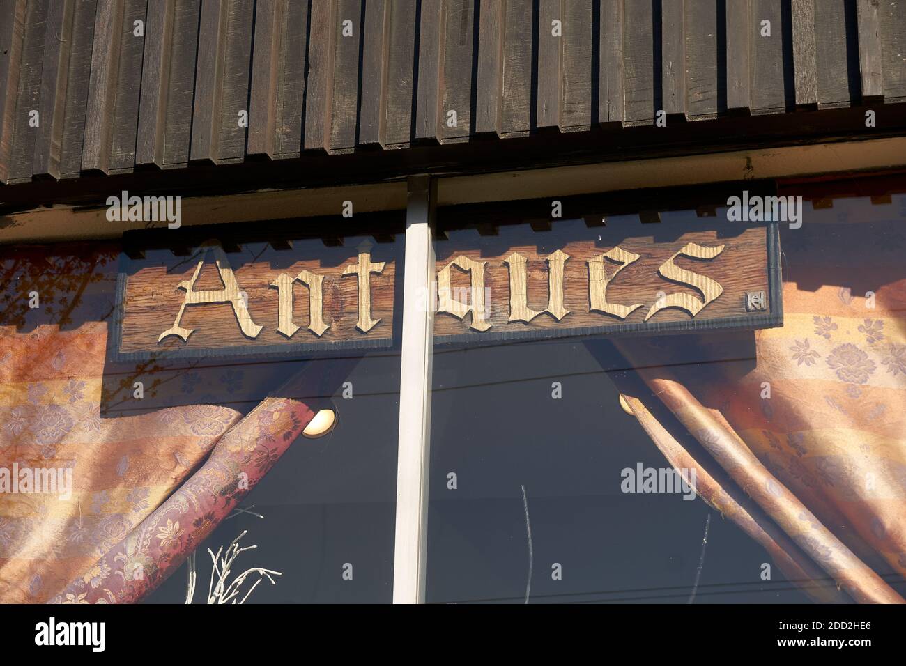 Antiques sign in the widow of A Baker's Dozen antiques store on Main Street, Vancouver, British