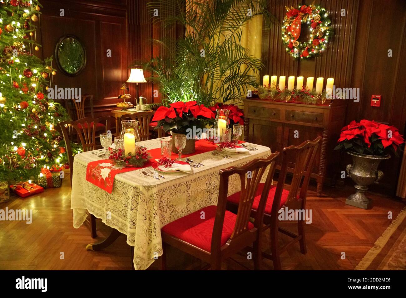 A dinner room and table decorated for Christmas Stock Photo