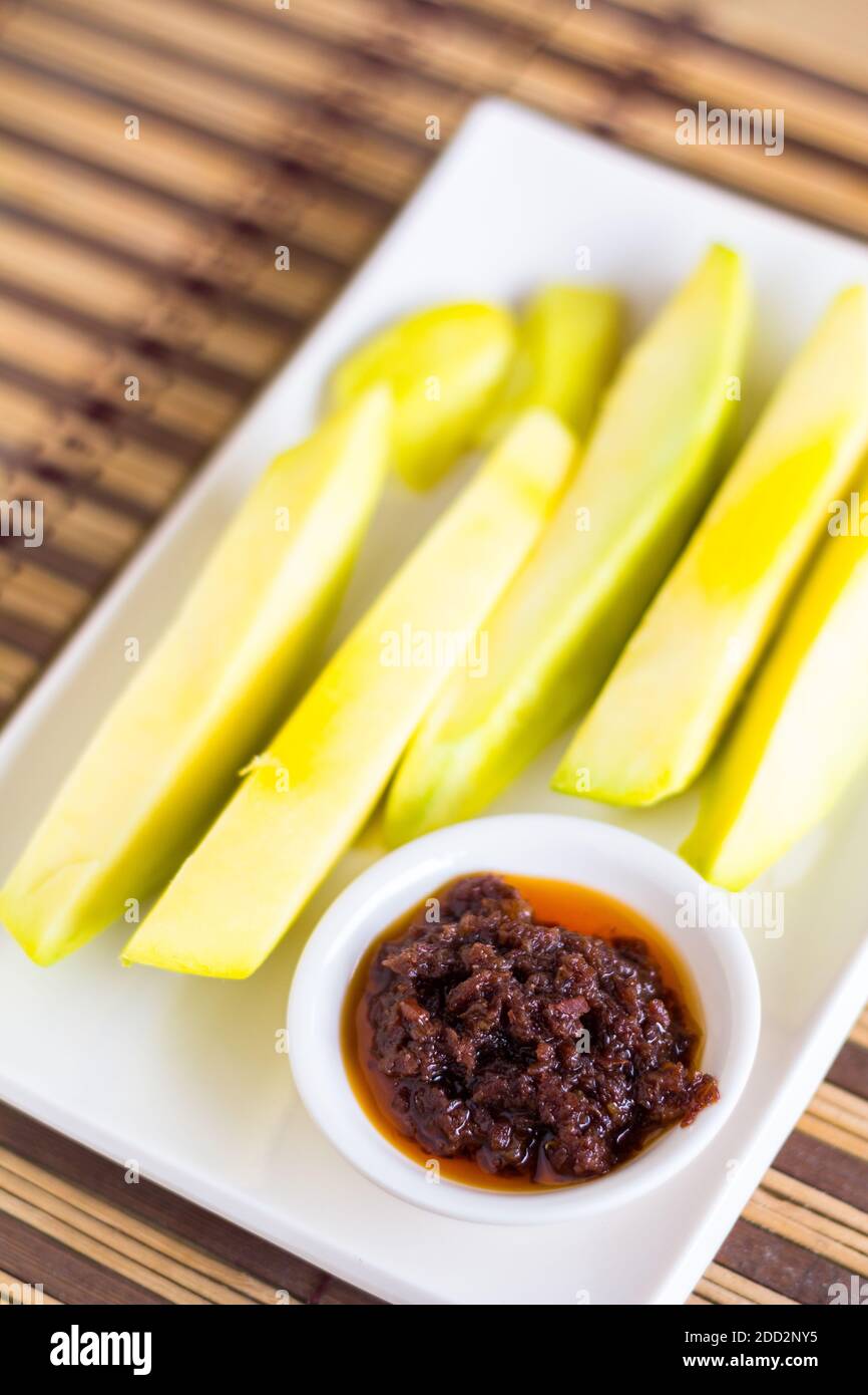 Slices of green mangos with traditional Filipino fermented shrimp paste Stock Photo