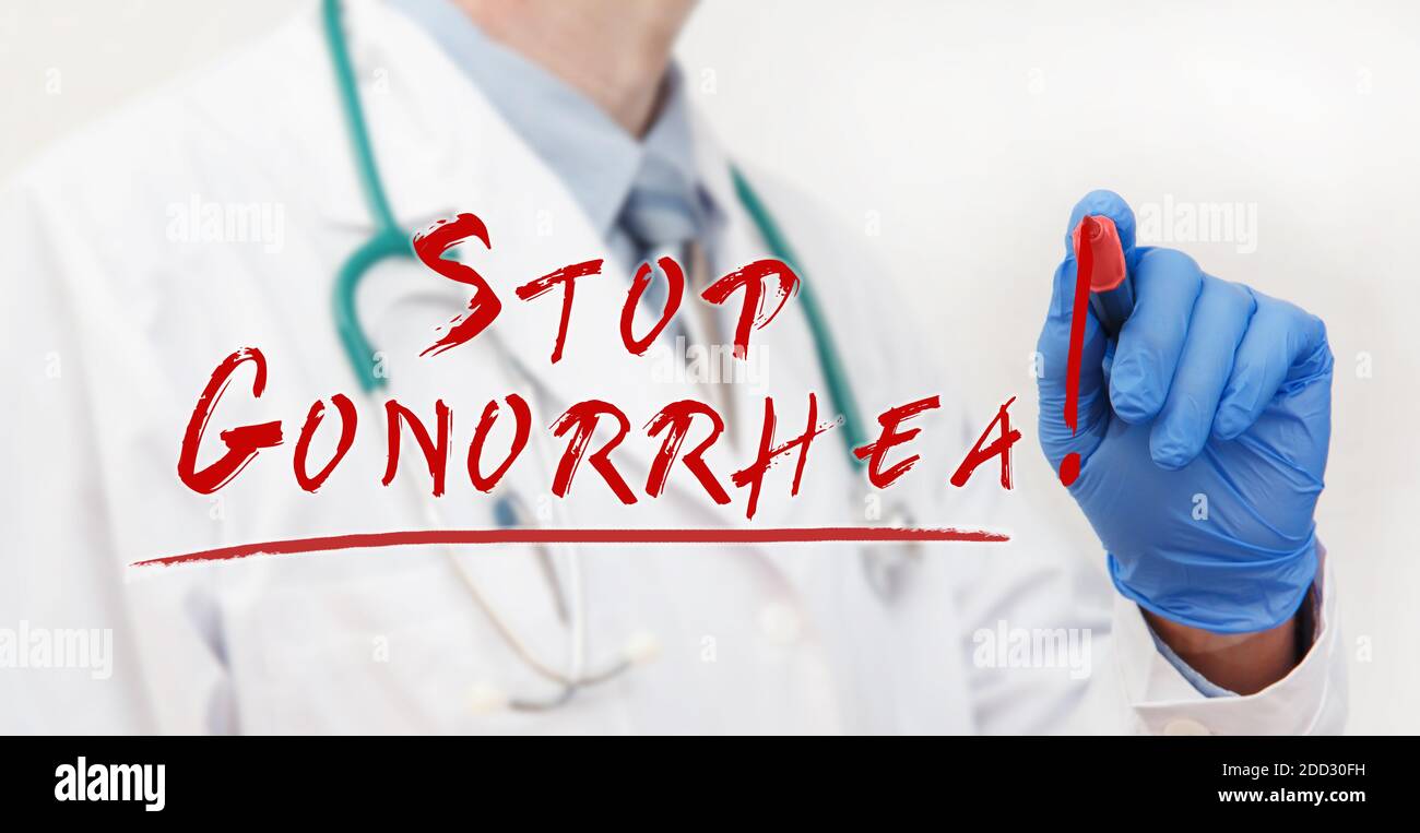 Doctor's hand writing with a marker Stop Gonorrhea. Medical concept Stock Photo