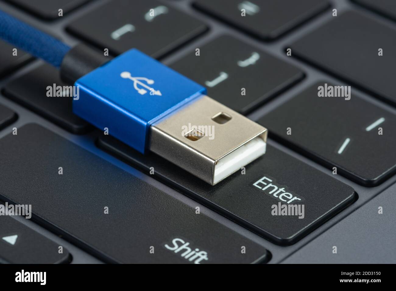 Usb with plug cable on button enter of laptop keyboard Stock Photo - Alamy
