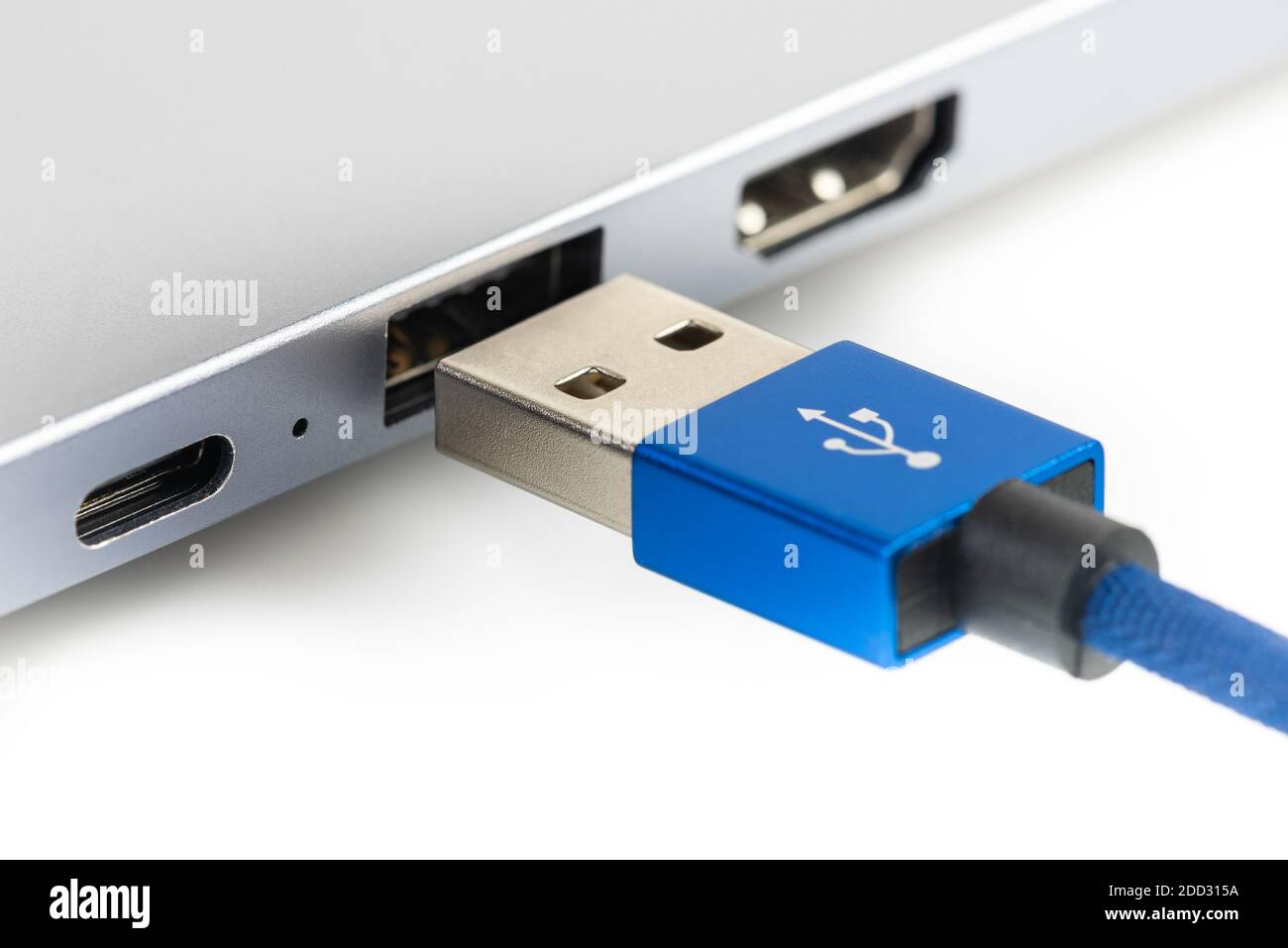 Usb cable connect to laptop closeup isolated on white background Stock