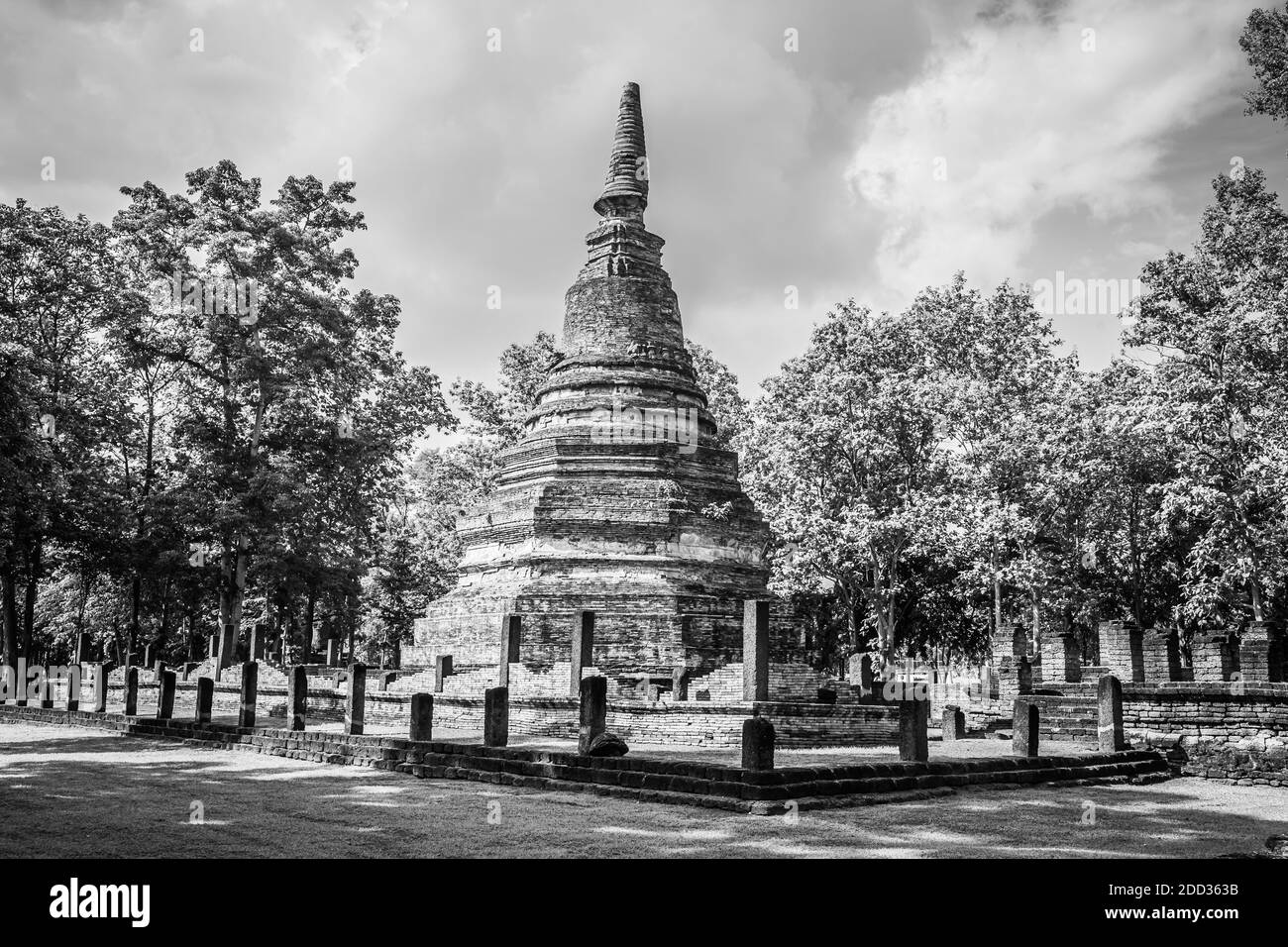 Landmark of old chedi made of ancient bricks in the Kamphaeng Phet Historical Park, Thailand. Black and white Stock Photo
