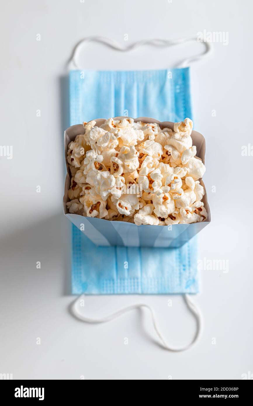 Popcorn box and mask on white background. Concept of coronavirus and  protective Stock Photo - Alamy