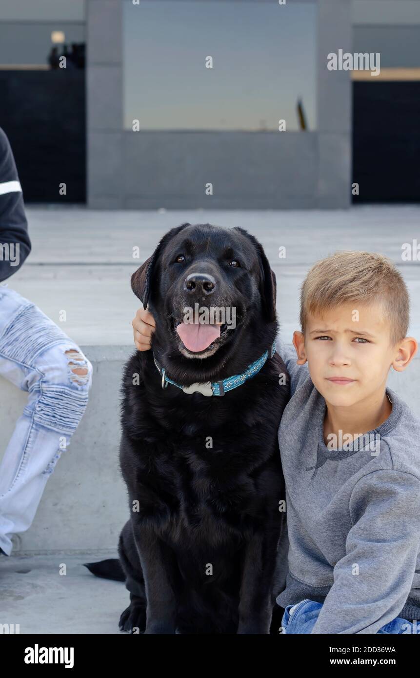 Love pets concept. Child and dog. An eightyearold boy in his arms
