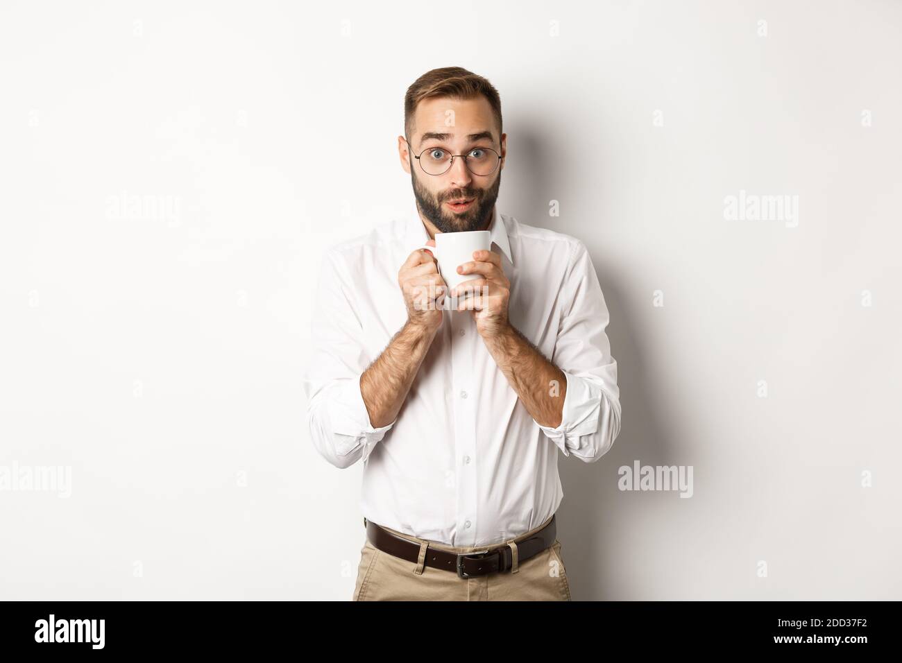 Happy office worker drinking hot coffee and looking excited, gossiping