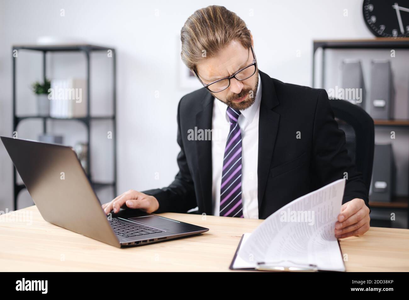 Businessman working with laptop and documents Stock Photo