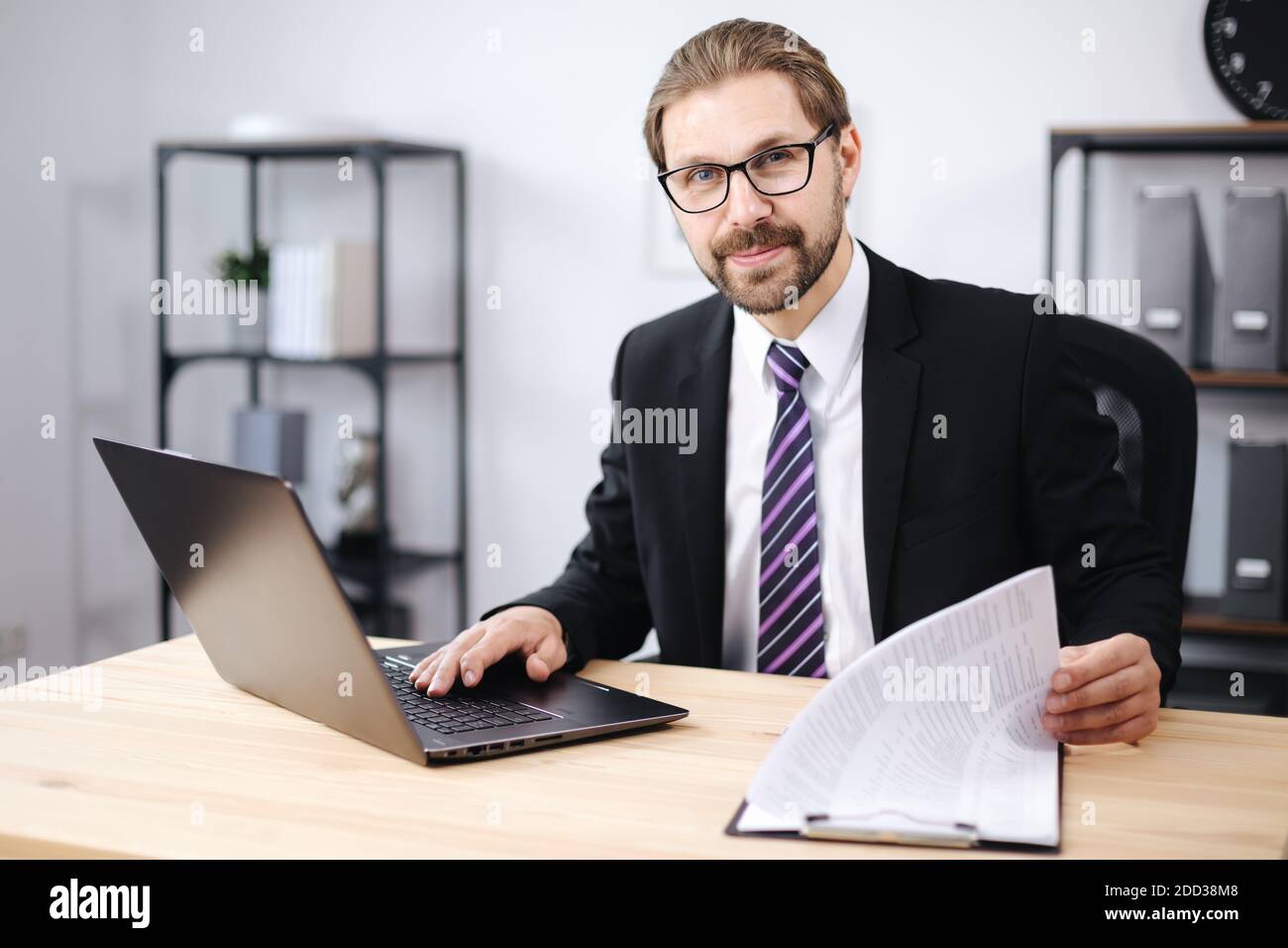 Happy man using laptop at office Stock Photo
