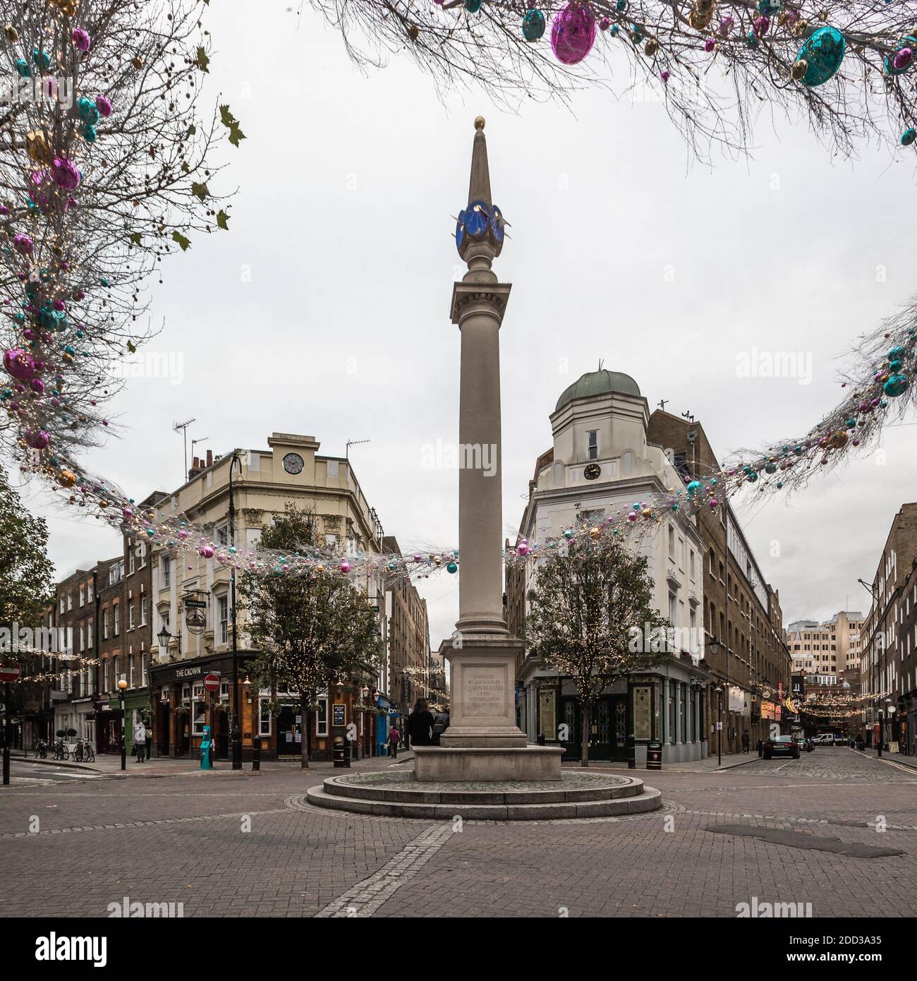 Christmas decorations go up at the famous tourist destination of Seven Dials in Covent Garden, London. Stock Photo