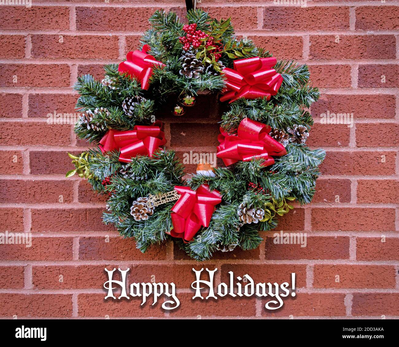 Christmas Wreath with red ribbons, pine cones and a robin, with Happy ...