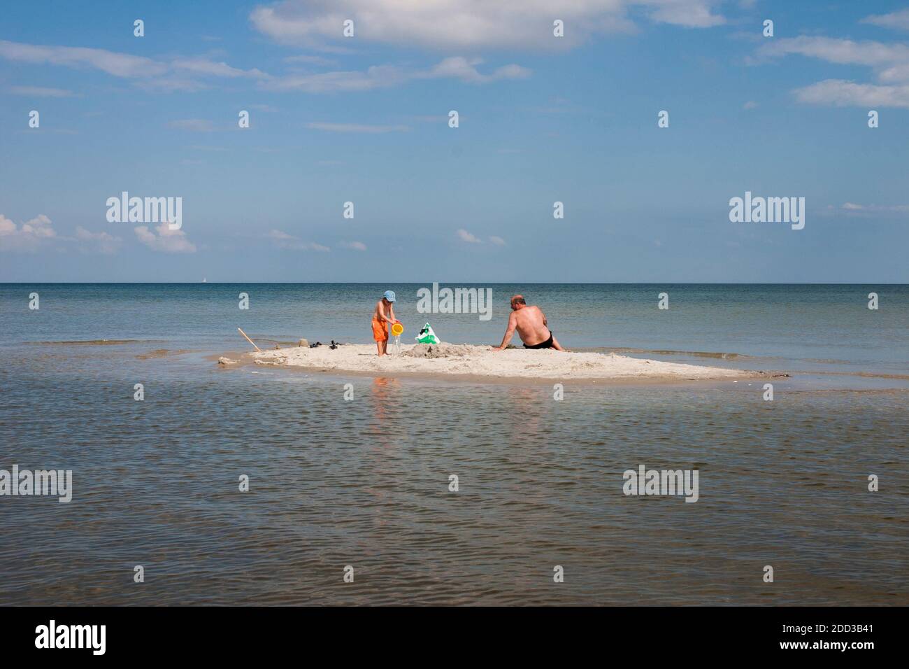 A man with a child on a small island. Stock Photo