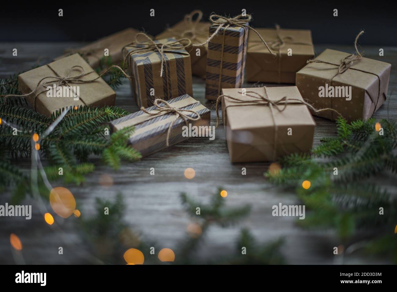 Christmas background. Gift boxes wrapped in craft paper, fir branches ...