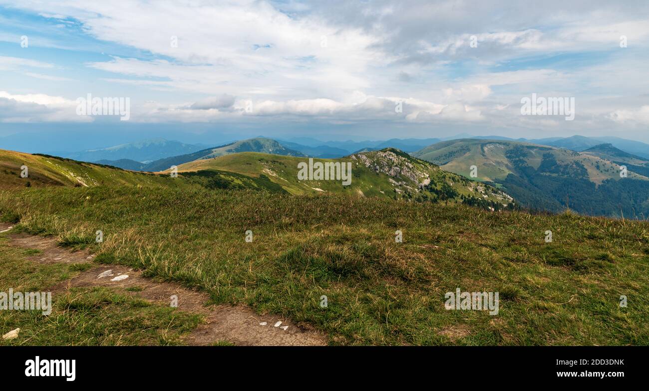 View from Ostredok hill summit in Velka Fatra mountains in Slovakia during late summer day with blue sky and clouds Stock Photo