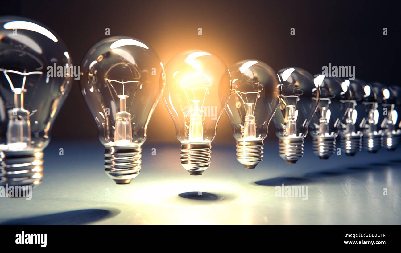 A row of lightbulbs with one brigthly lit - concept for having an idea, innovation, standing out. Diminshing perspective Stock Photo