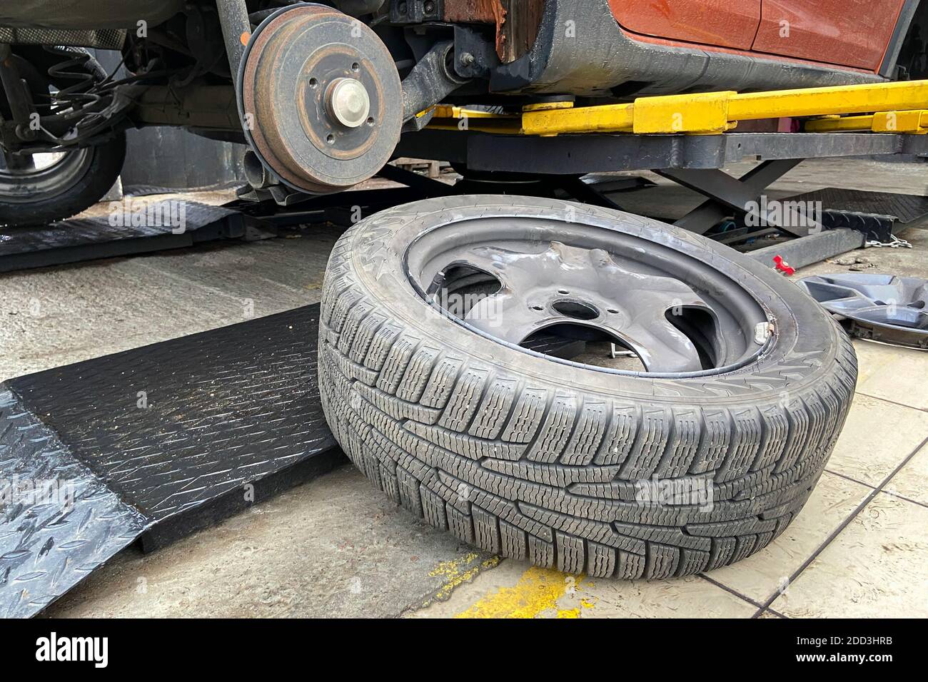 Car repair concept. Technicians are changing tires. Wheel balancing or