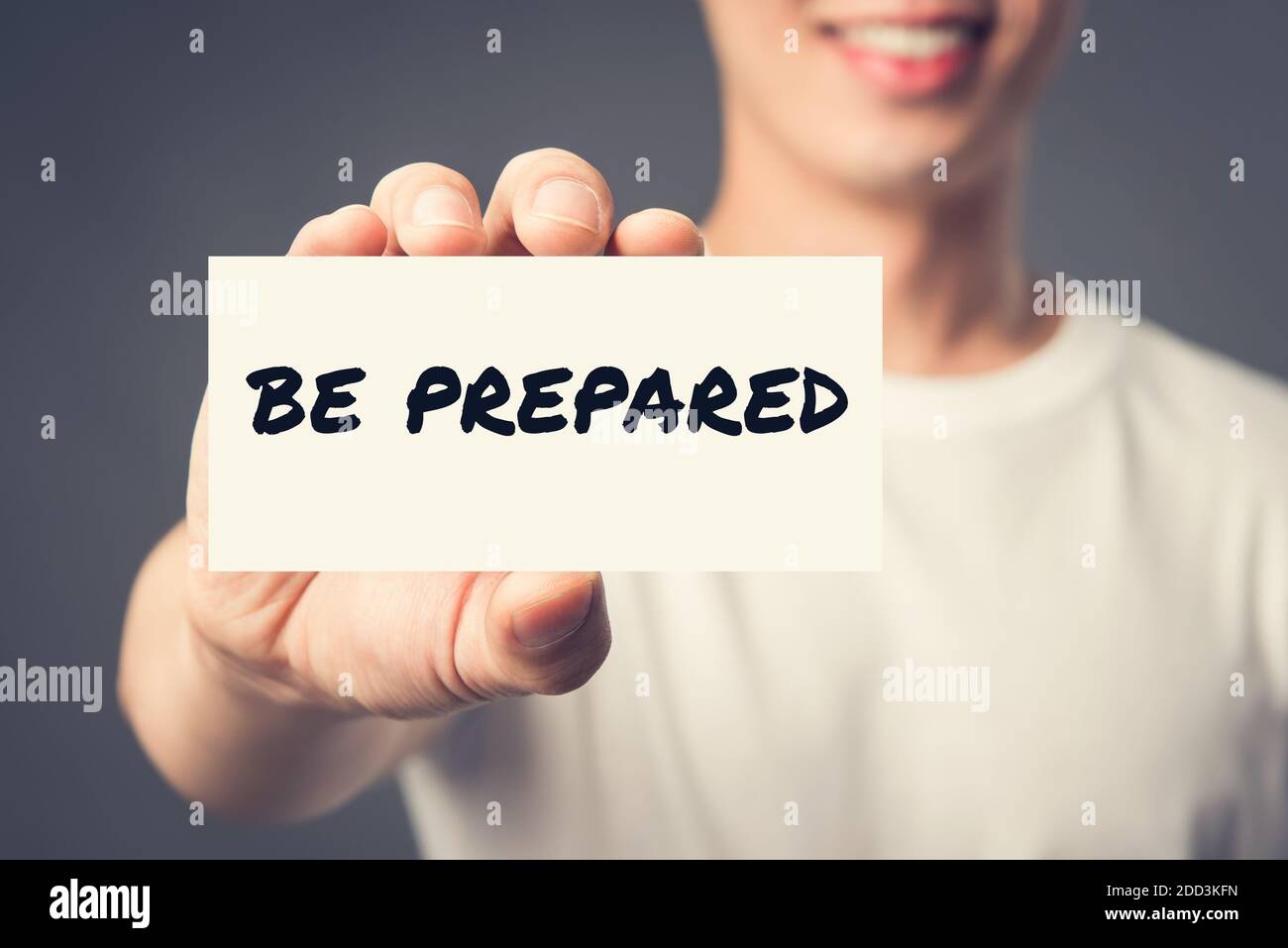 BE PREPARED, message on the card shown by a man, vintage tone effect Stock Photo