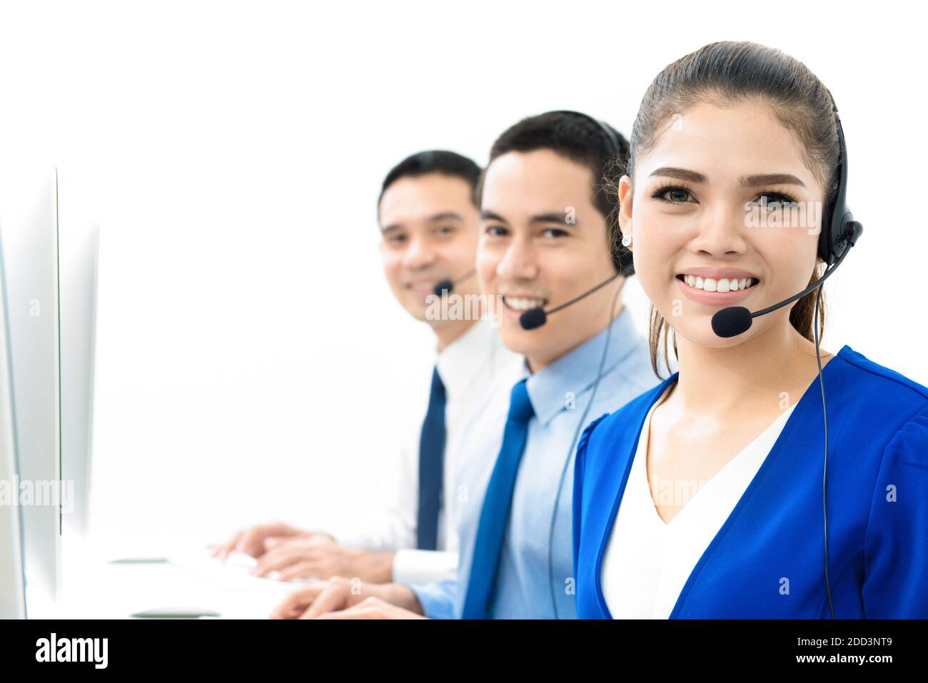 Smiling Asian call center (or telemarketer) team Stock Photo
