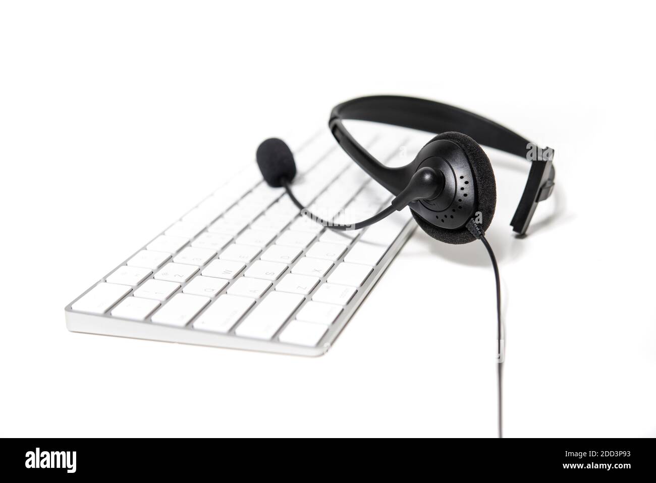 Microphone headset on computer keyboard Stock Photo Alamy