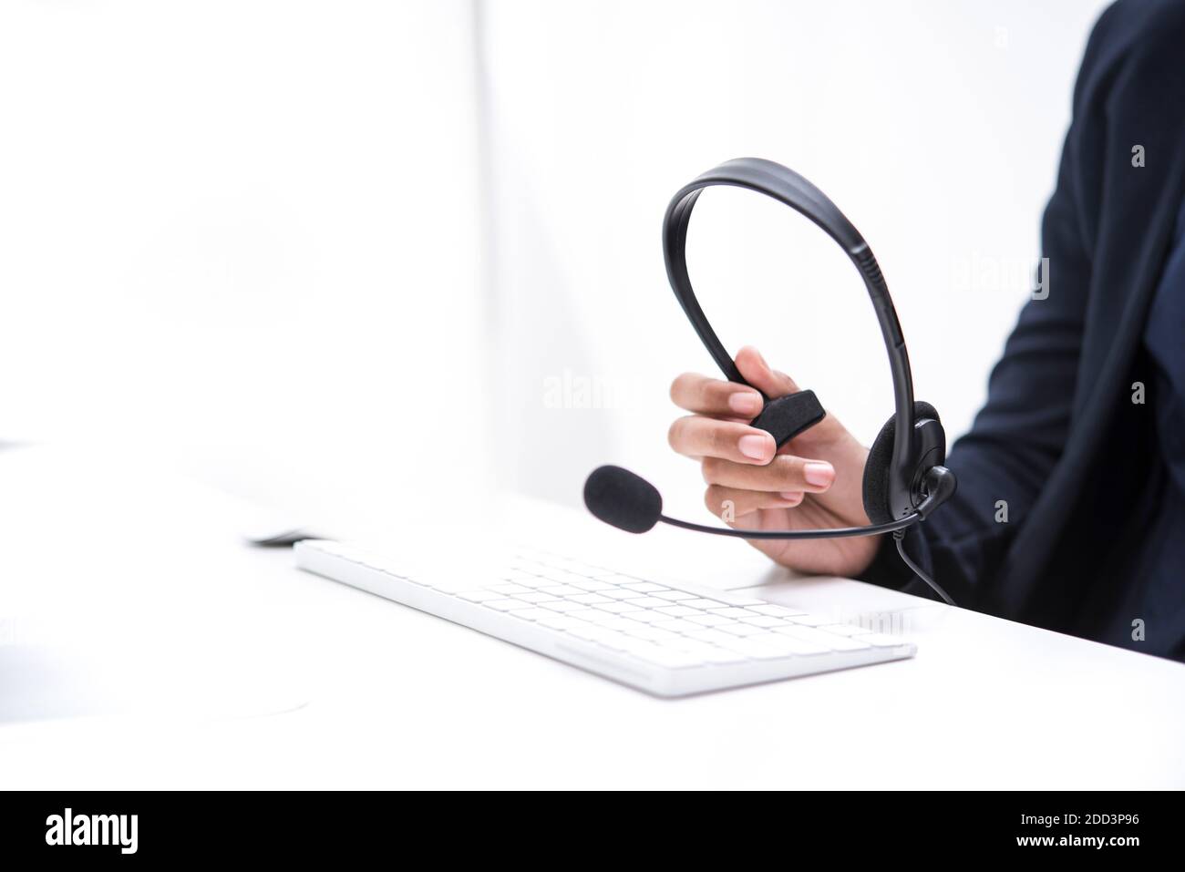Woman hand holding microphone headset  - call center, telemarketer concepts Stock Photo