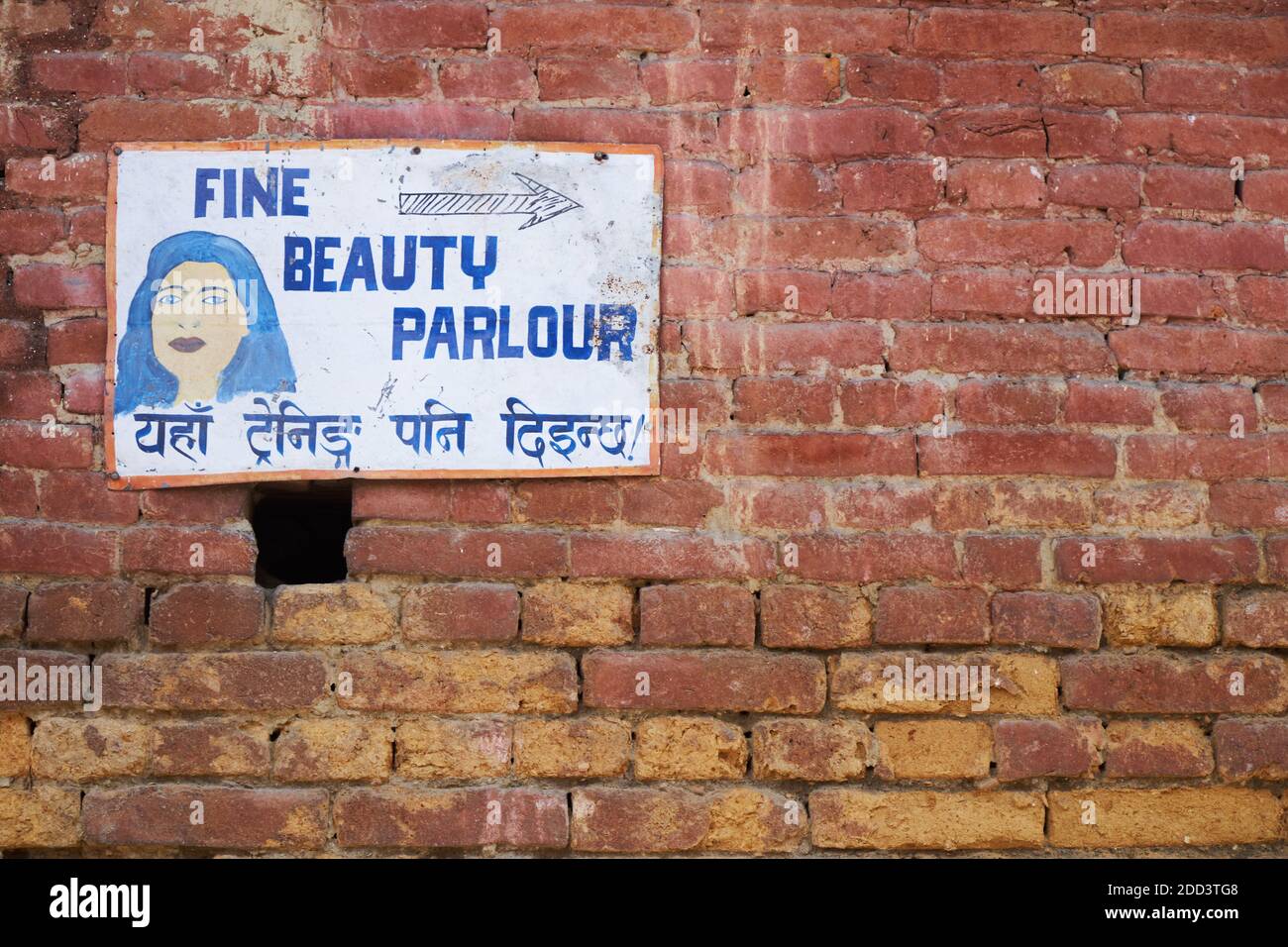 An unsophisticated, child-like drawing advertising a beauty parlor in Bhaktapur, Nepal; the sentence in Nepali says that training is also available Stock Photo