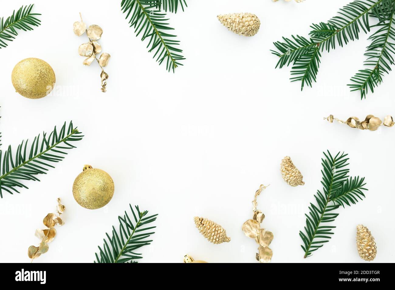 Christmas frame of evergreen tree branches and golden decoration on ...