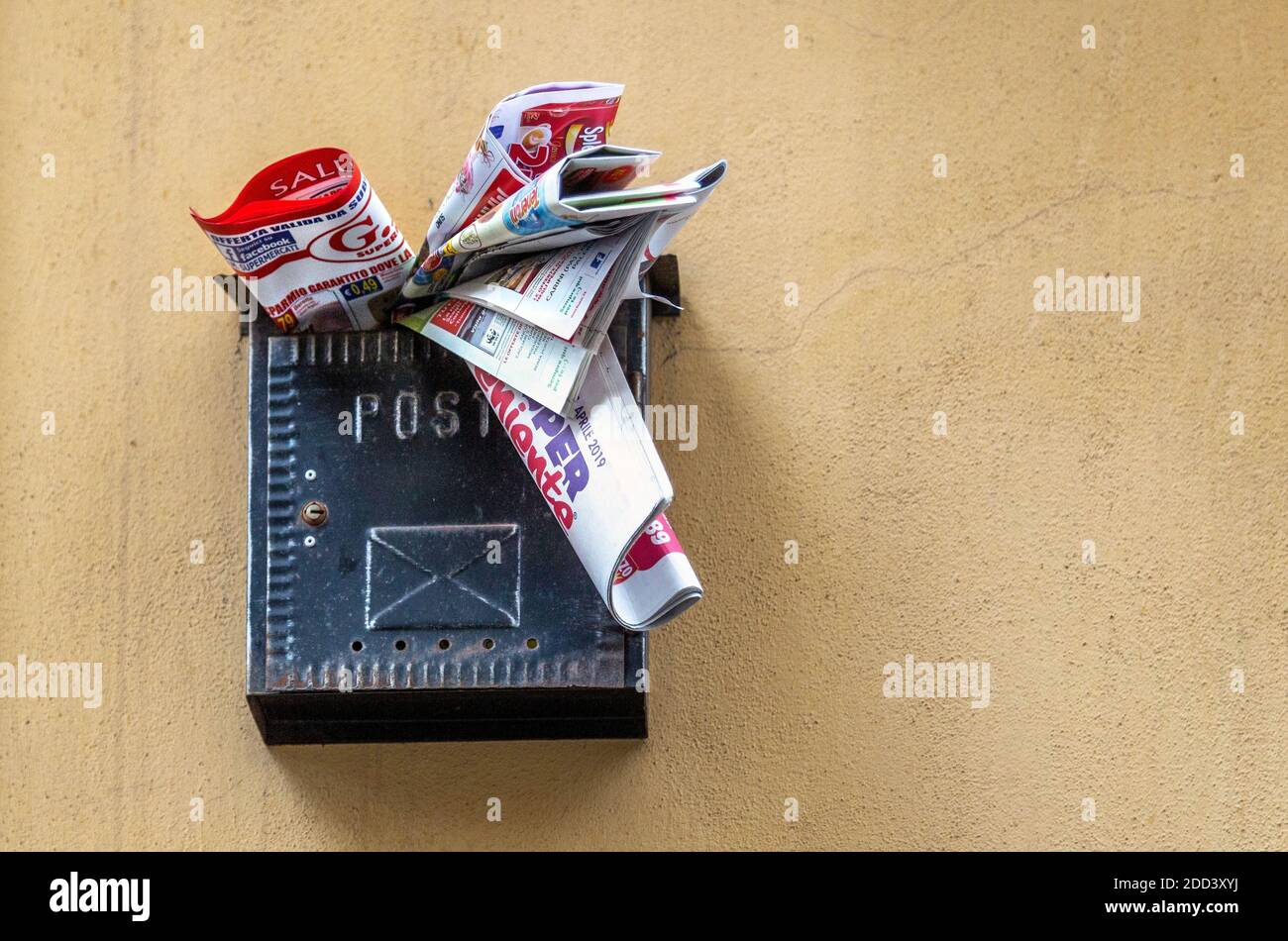Junk mail in a mailbox in Catania Sicily, Italy Stock Photo