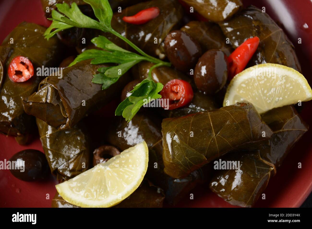 Traditional Greek cuisine. Wrapped rice in grape leaves. Dolma with lemon, spices, various