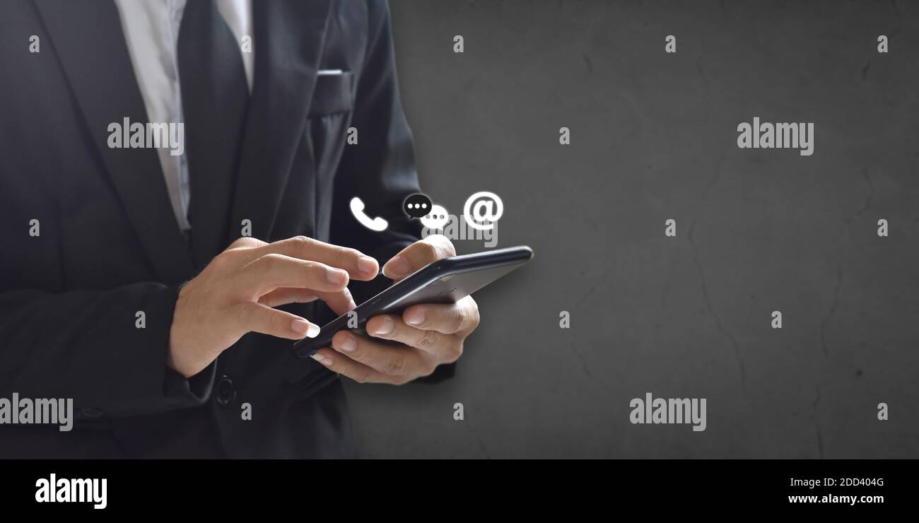 Businessman holding smartphone with ( message, calling, email ) icon. Concept of contact, support people or contacting information on business. Stock Photo