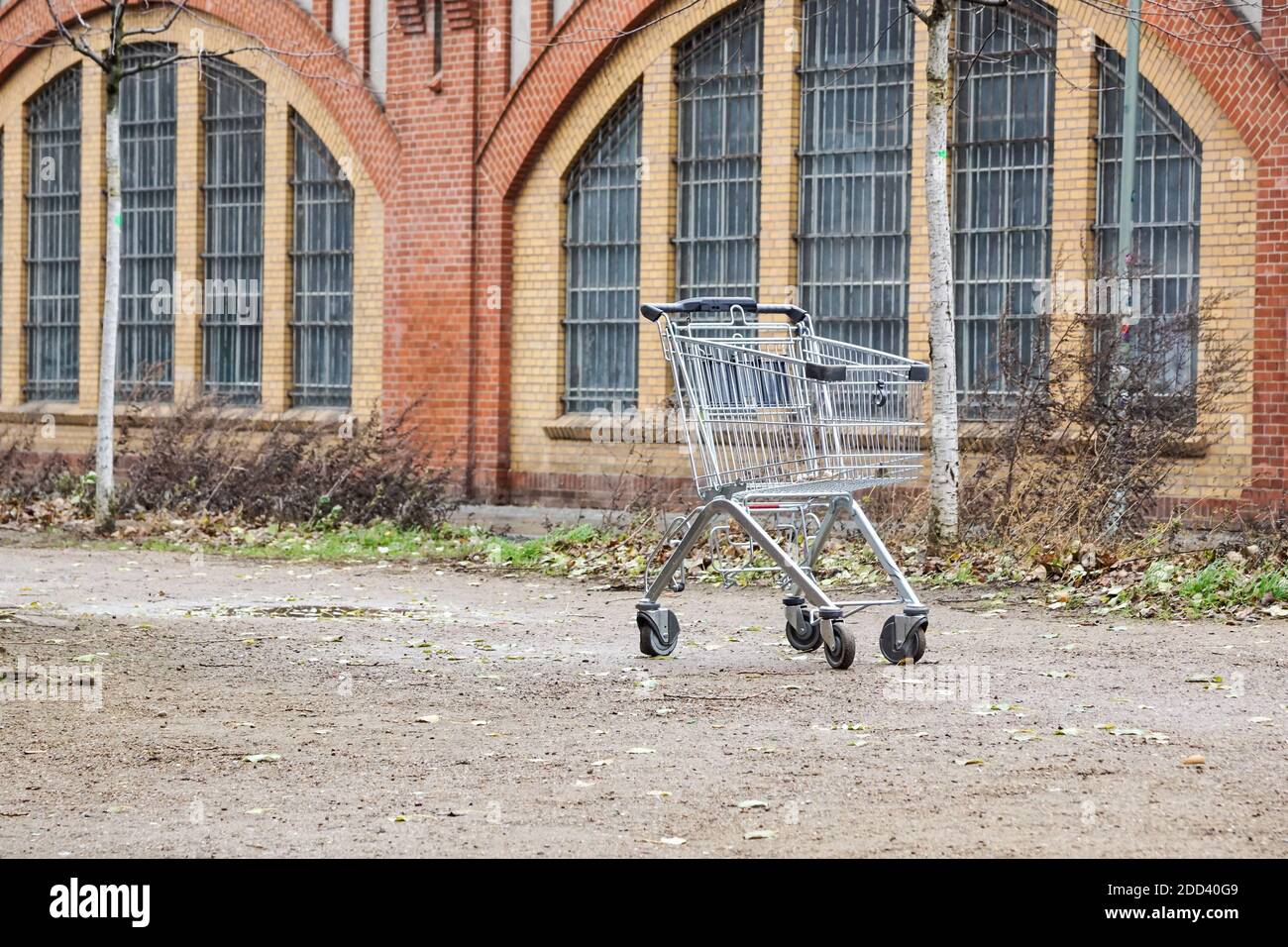 empty shopping cart . trade crisis, abandoned shopping cart in a deserted, empty industrial area. Symbol of the suburbs of abandoned cities or cities Stock Photo