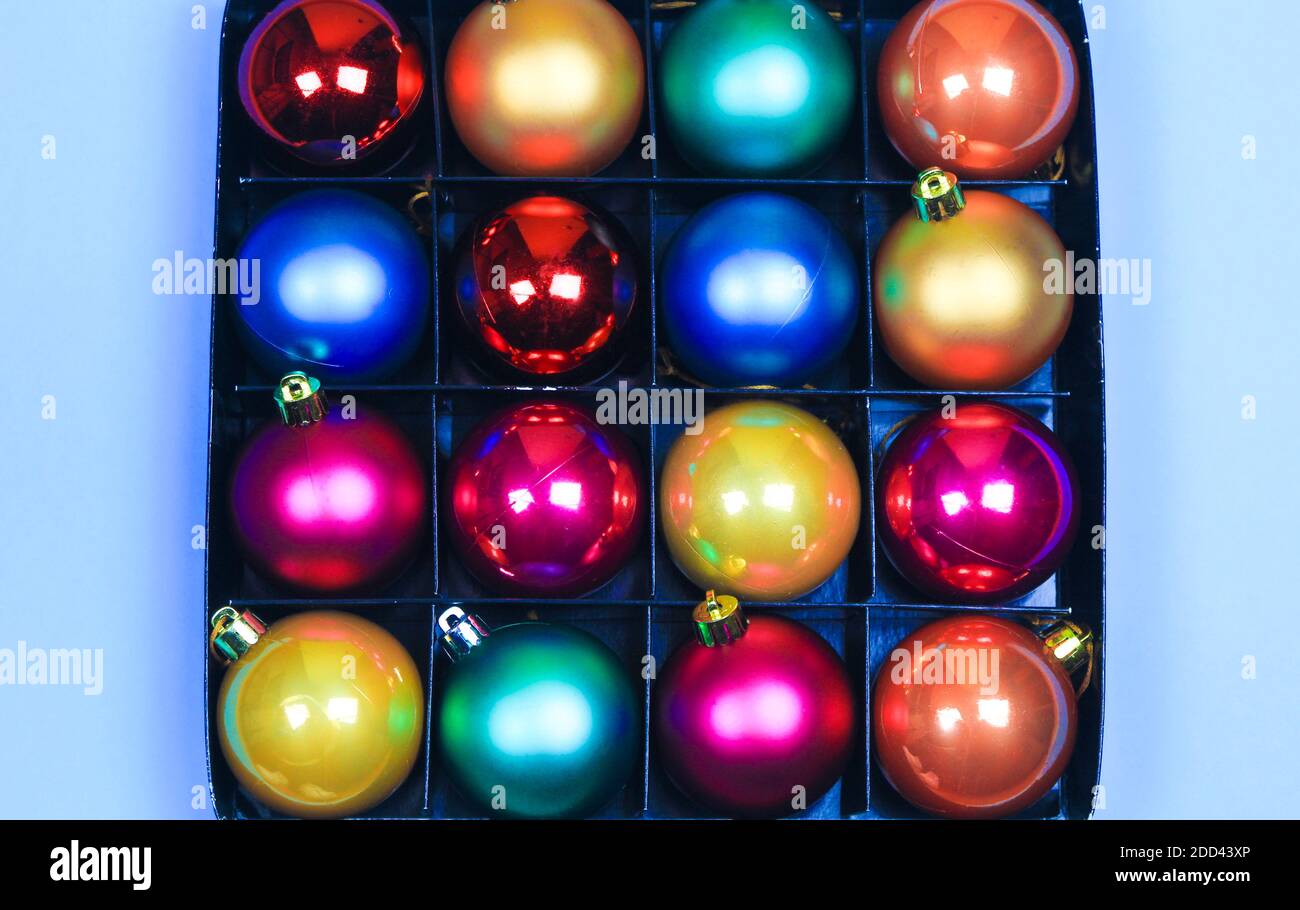 Box of multicolor Christmas balls on blue background Stock Photo